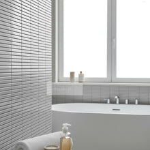 Załaduj obraz do przeglądarki galerii, imozaiki.pl white glossy ceramic mosaic tiles with a subtle horizontal ribbed texture in a modern bathroom setting.